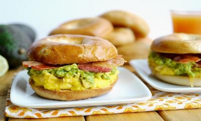 Bagel, cheese, avocado, and egg sandwich